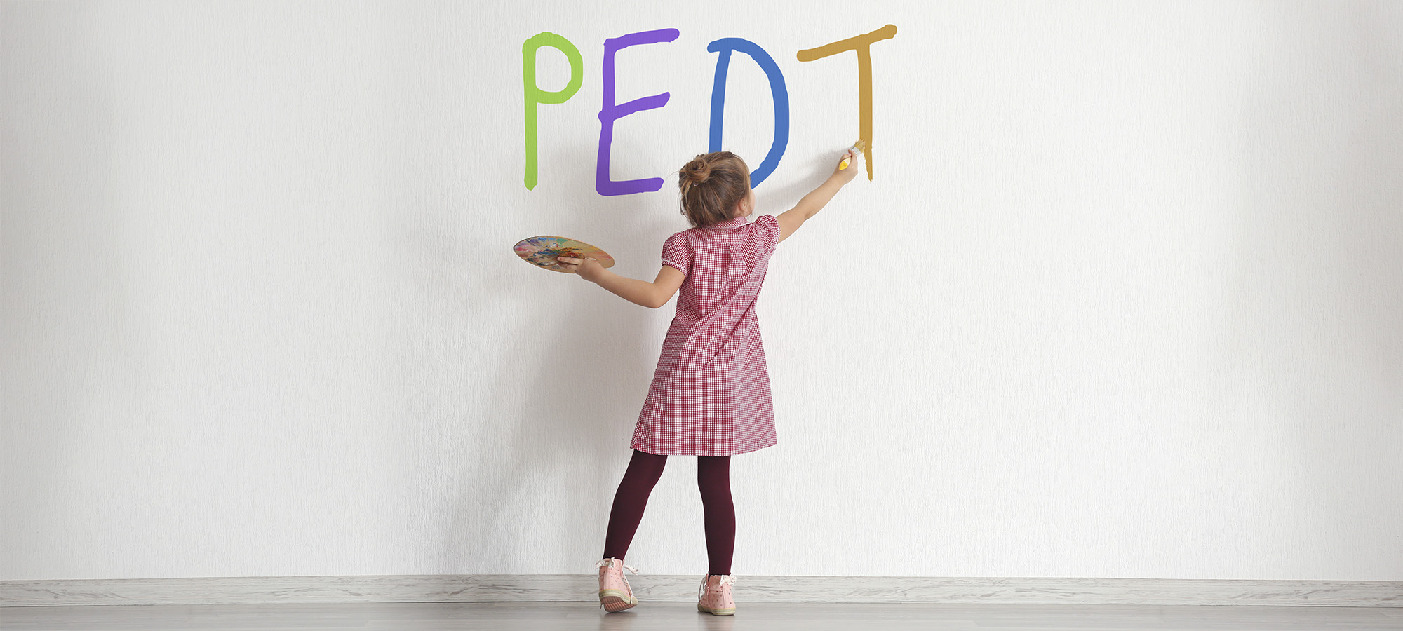 Cute little girl painting on wall in empty room Cute little girl painting on wall in empty room